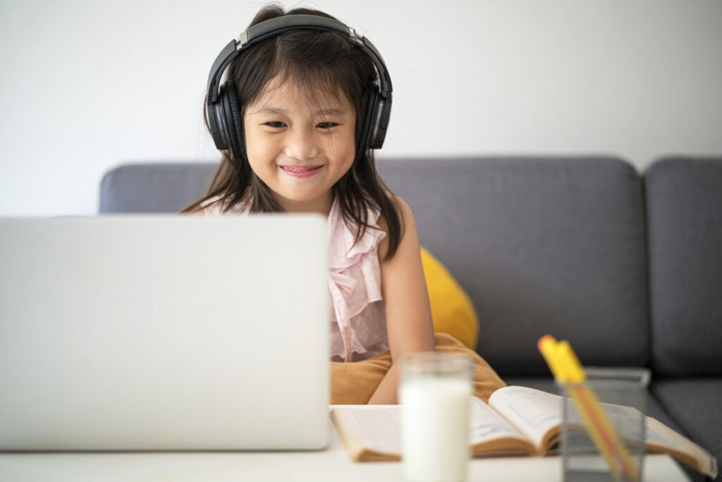 Asian girl using laptop for online study during homeschooling at home during Coronavirus or Covid-19 virus outbreak situation