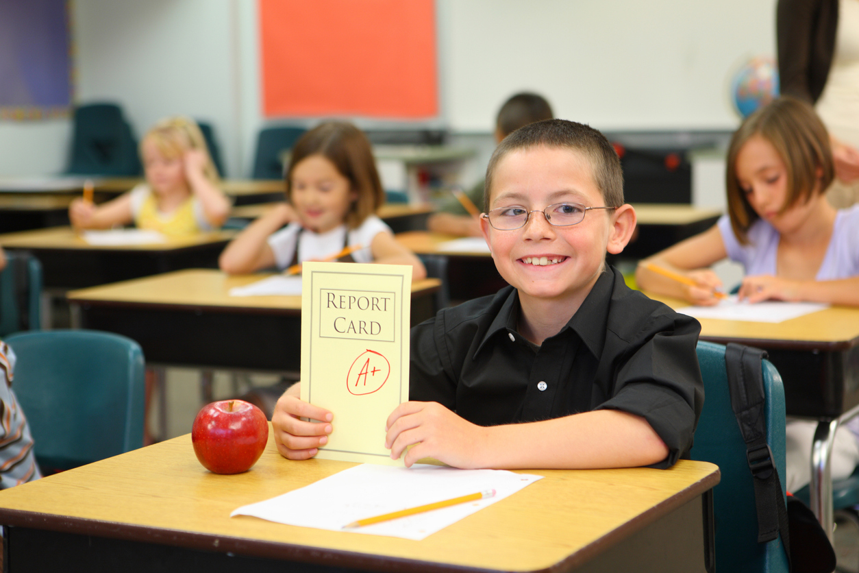 Child at school with report card